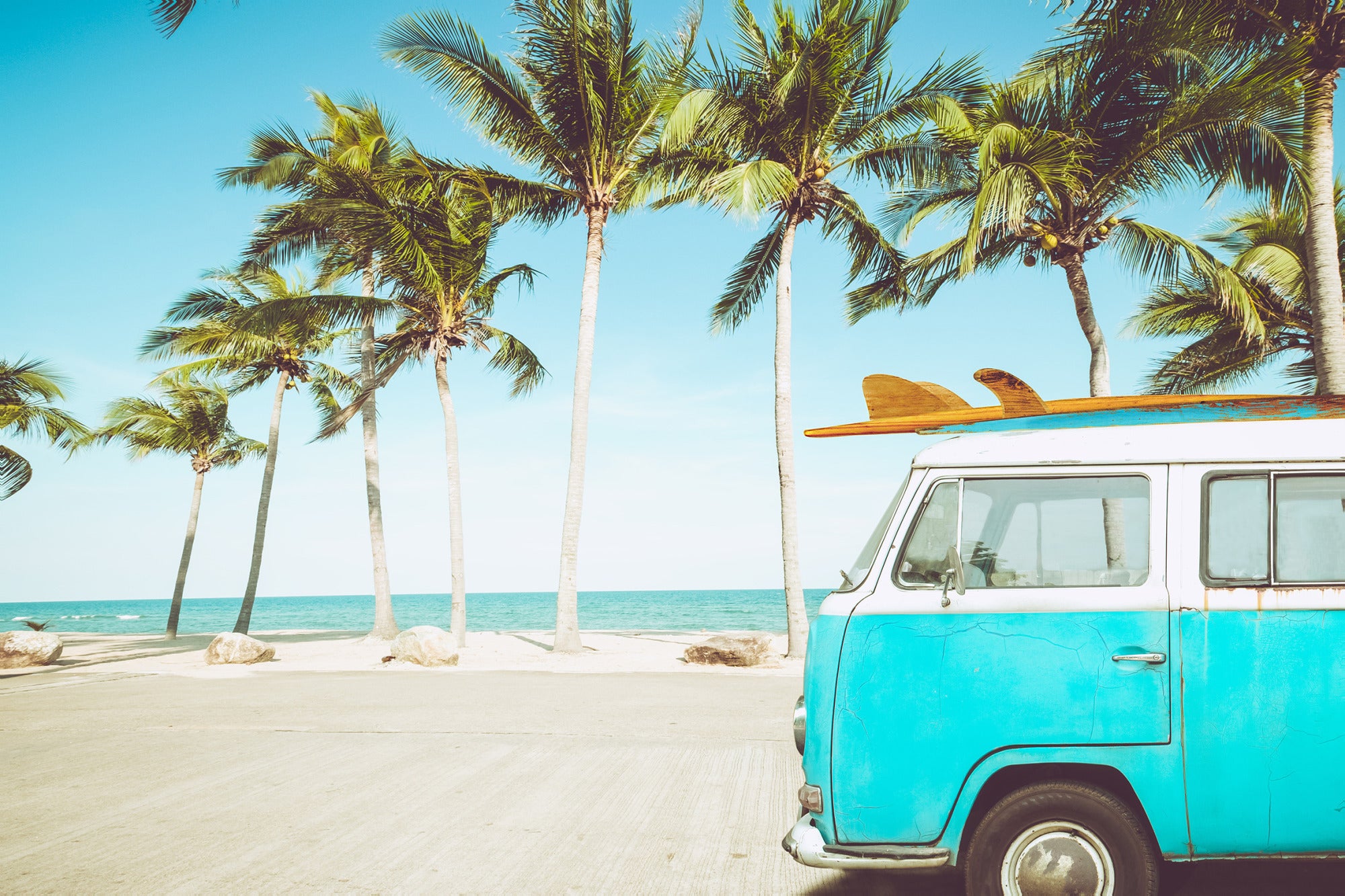 Niebieski bus z deskami surfingowymi